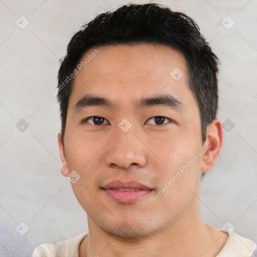 Joyful asian young-adult male with short  black hair and brown eyes