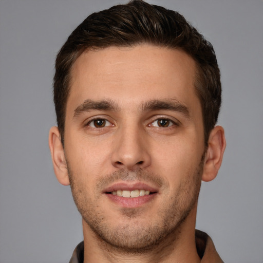 Joyful white young-adult male with short  brown hair and brown eyes