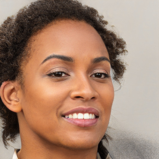 Joyful black young-adult female with medium  brown hair and brown eyes