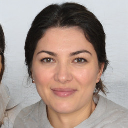 Joyful white adult female with medium  brown hair and brown eyes