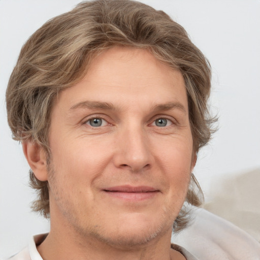 Joyful white adult male with short  brown hair and grey eyes