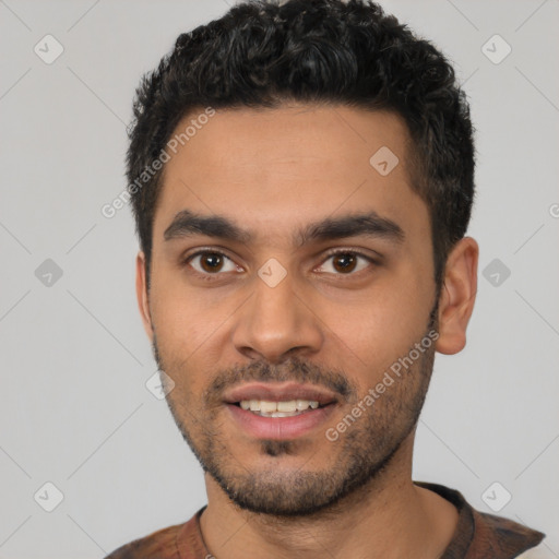 Joyful latino young-adult male with short  black hair and brown eyes