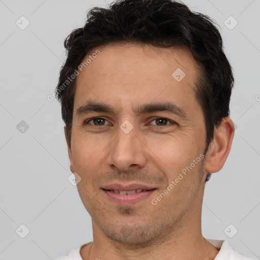 Joyful white young-adult male with short  black hair and brown eyes