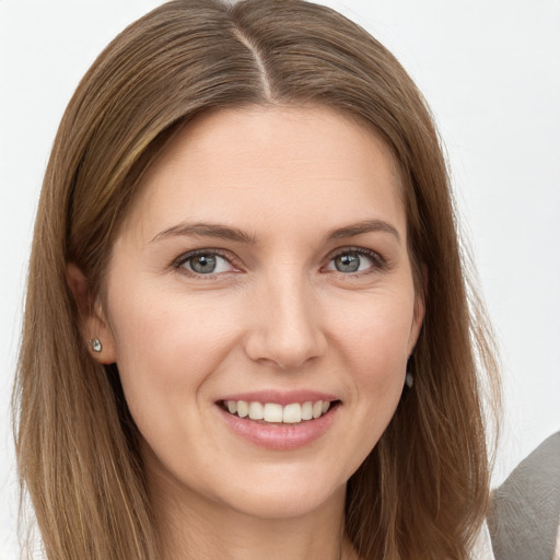 Joyful white young-adult female with long  brown hair and grey eyes