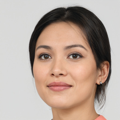 Joyful latino young-adult female with medium  black hair and brown eyes