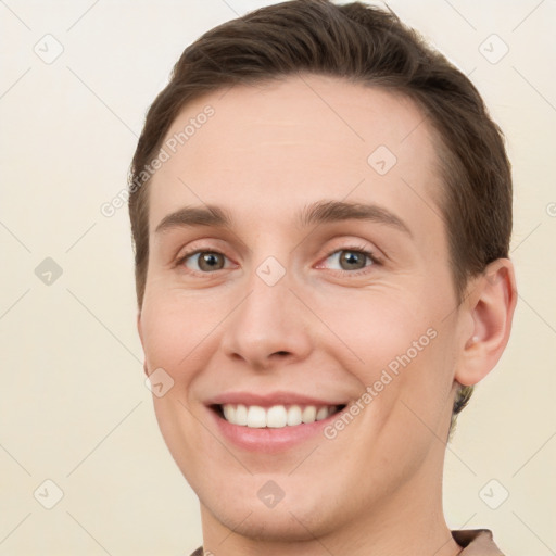 Joyful white young-adult female with short  brown hair and grey eyes