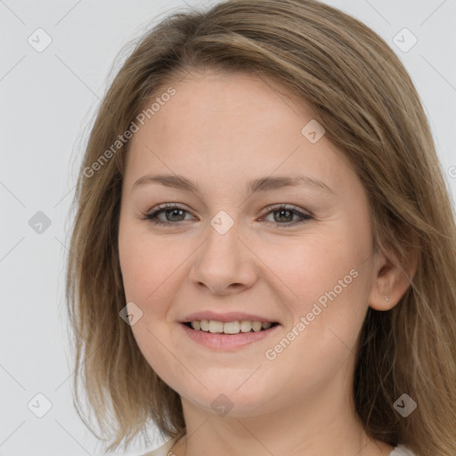 Joyful white young-adult female with long  brown hair and grey eyes