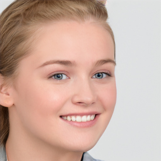 Joyful white young-adult female with long  brown hair and blue eyes