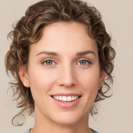 Joyful white young-adult female with medium  brown hair and green eyes