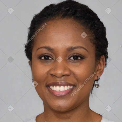 Joyful black young-adult female with short  black hair and brown eyes