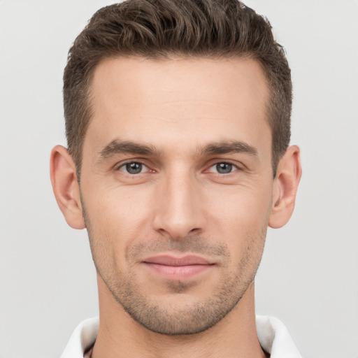 Joyful white young-adult male with short  brown hair and brown eyes