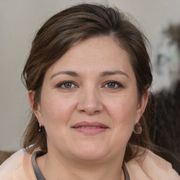 Joyful white adult female with medium  brown hair and grey eyes