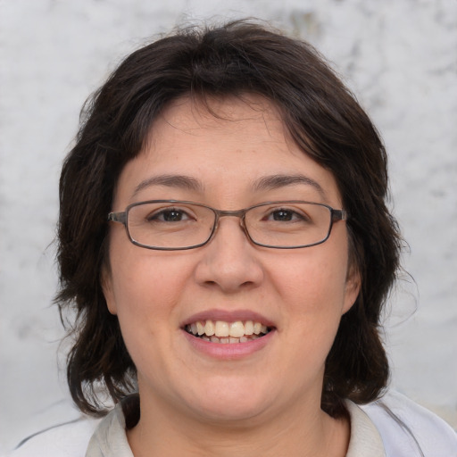 Joyful white adult female with medium  brown hair and brown eyes