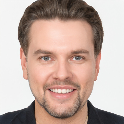 Joyful white young-adult male with short  brown hair and grey eyes