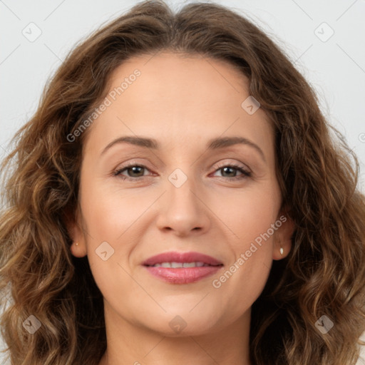 Joyful white adult female with long  brown hair and brown eyes