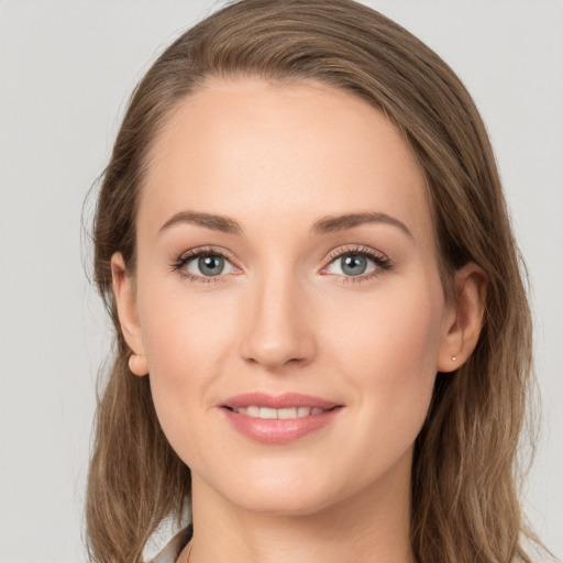 Joyful white young-adult female with long  brown hair and grey eyes