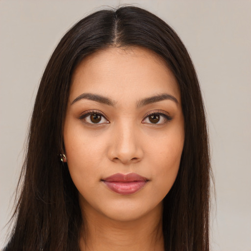 Joyful latino young-adult female with long  brown hair and brown eyes