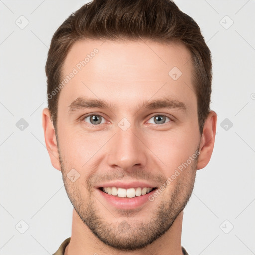 Joyful white young-adult male with short  brown hair and grey eyes