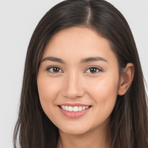 Joyful white young-adult female with long  brown hair and brown eyes