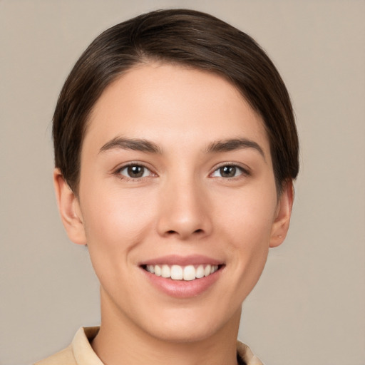 Joyful white young-adult female with short  brown hair and brown eyes