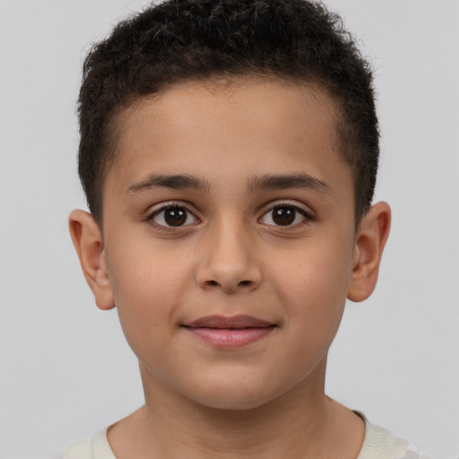 Joyful latino child male with short  brown hair and brown eyes