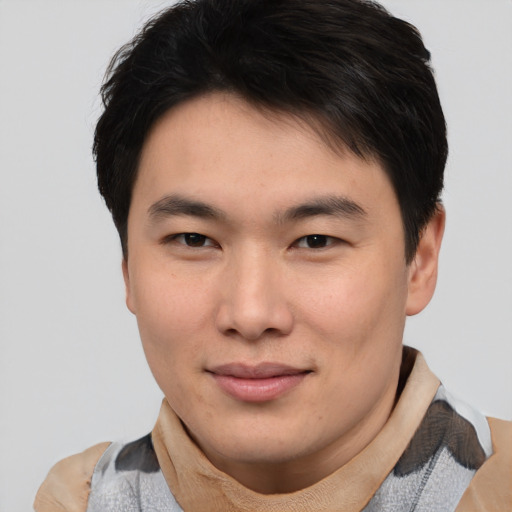 Joyful asian young-adult male with short  brown hair and brown eyes