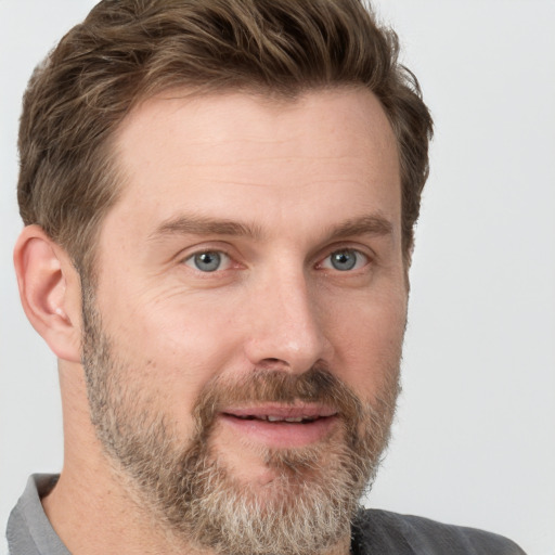 Joyful white adult male with short  brown hair and grey eyes