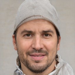 Joyful white adult male with short  brown hair and grey eyes