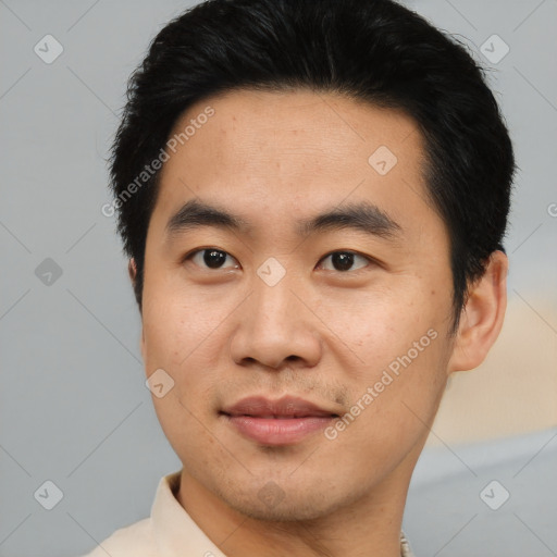 Joyful asian young-adult male with short  brown hair and brown eyes