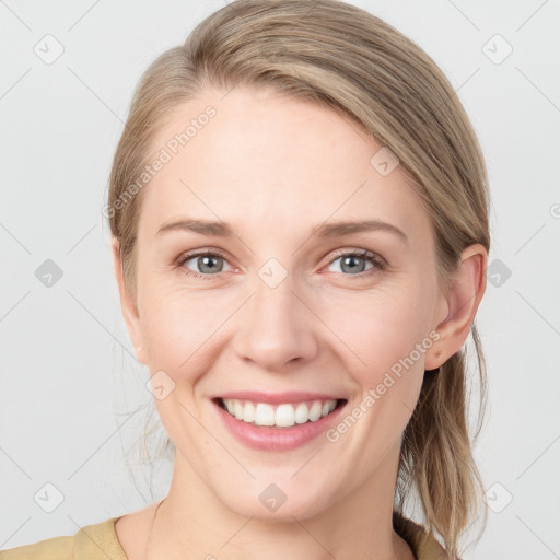 Joyful white young-adult female with medium  brown hair and blue eyes