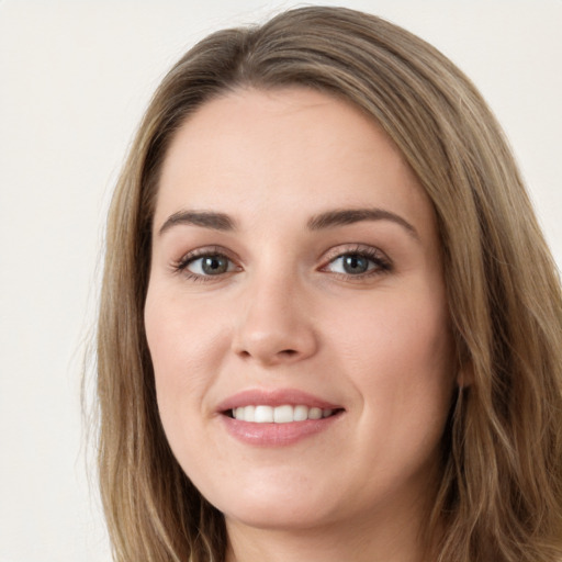 Joyful white young-adult female with long  brown hair and green eyes