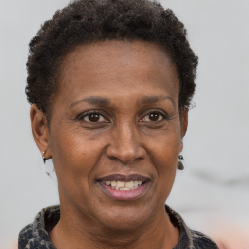 Joyful black adult female with short  brown hair and brown eyes