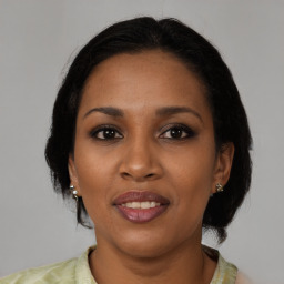 Joyful black adult female with medium  black hair and brown eyes