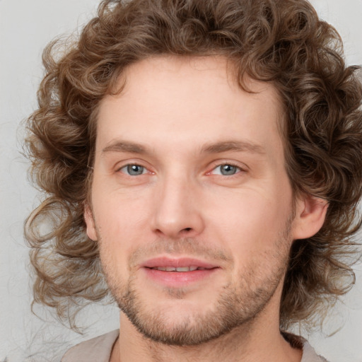 Joyful white young-adult male with medium  brown hair and brown eyes