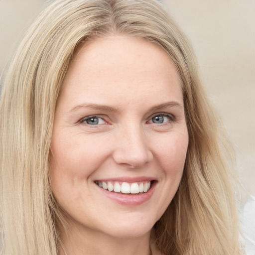 Joyful white young-adult female with long  brown hair and blue eyes