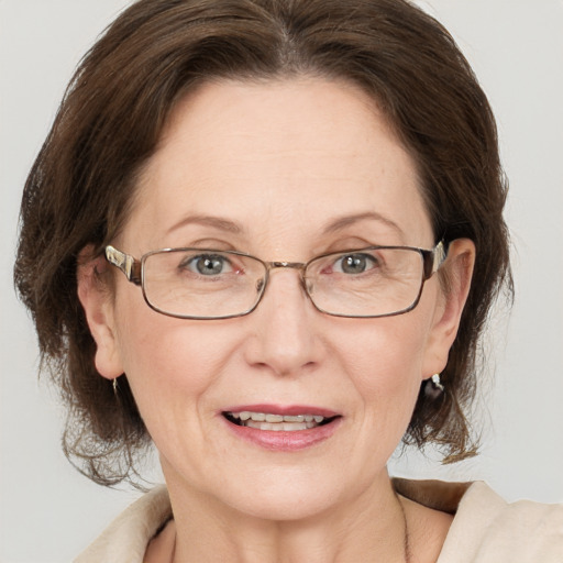 Joyful white adult female with medium  brown hair and grey eyes