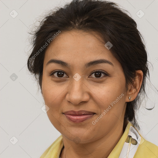 Joyful latino adult female with medium  brown hair and brown eyes