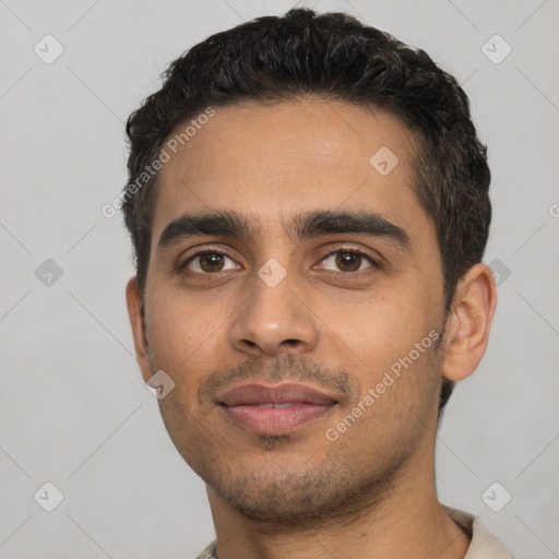 Joyful latino young-adult male with short  black hair and brown eyes