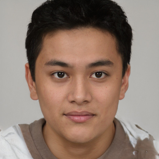 Joyful latino young-adult male with short  brown hair and brown eyes