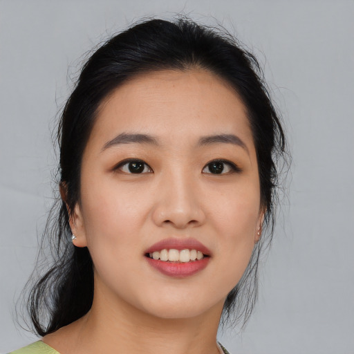 Joyful asian young-adult female with medium  black hair and brown eyes