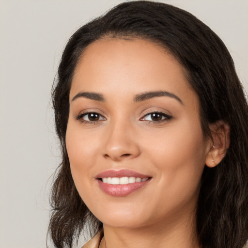 Joyful white young-adult female with long  black hair and brown eyes