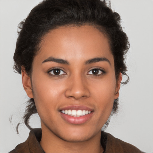 Joyful latino young-adult female with short  brown hair and brown eyes