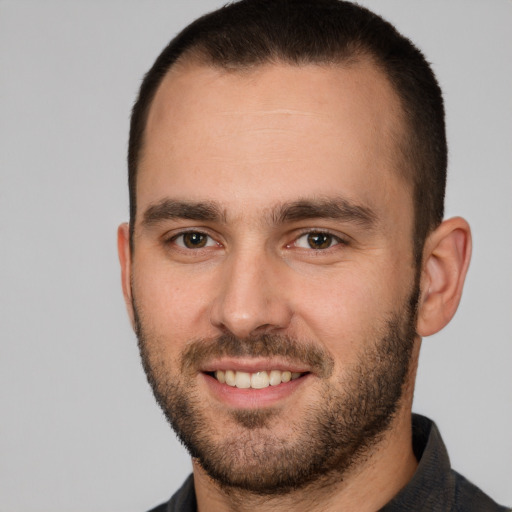 Joyful white young-adult male with short  brown hair and brown eyes