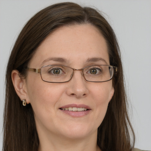 Joyful white adult female with long  brown hair and grey eyes