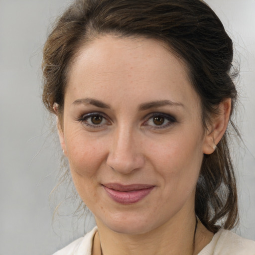 Joyful white adult female with medium  brown hair and brown eyes