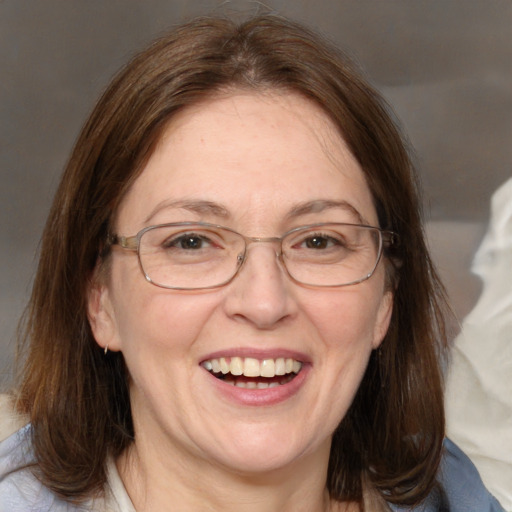 Joyful white adult female with medium  brown hair and blue eyes