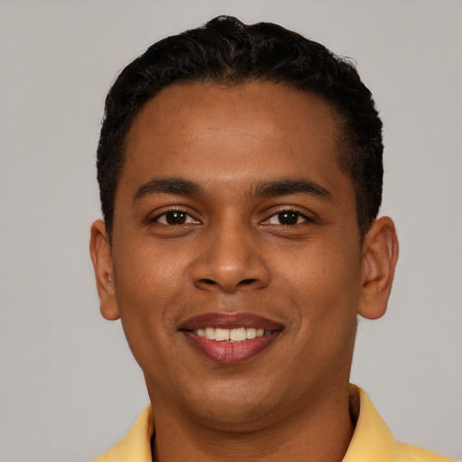 Joyful black young-adult male with short  brown hair and brown eyes