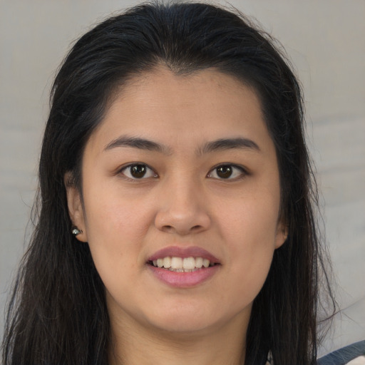 Joyful asian young-adult female with long  brown hair and brown eyes