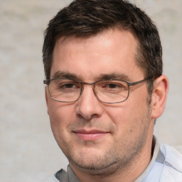 Joyful white adult male with short  brown hair and brown eyes