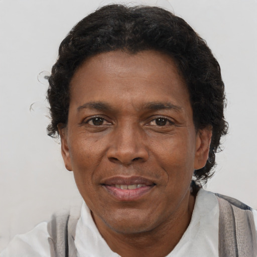 Joyful black adult male with short  brown hair and brown eyes